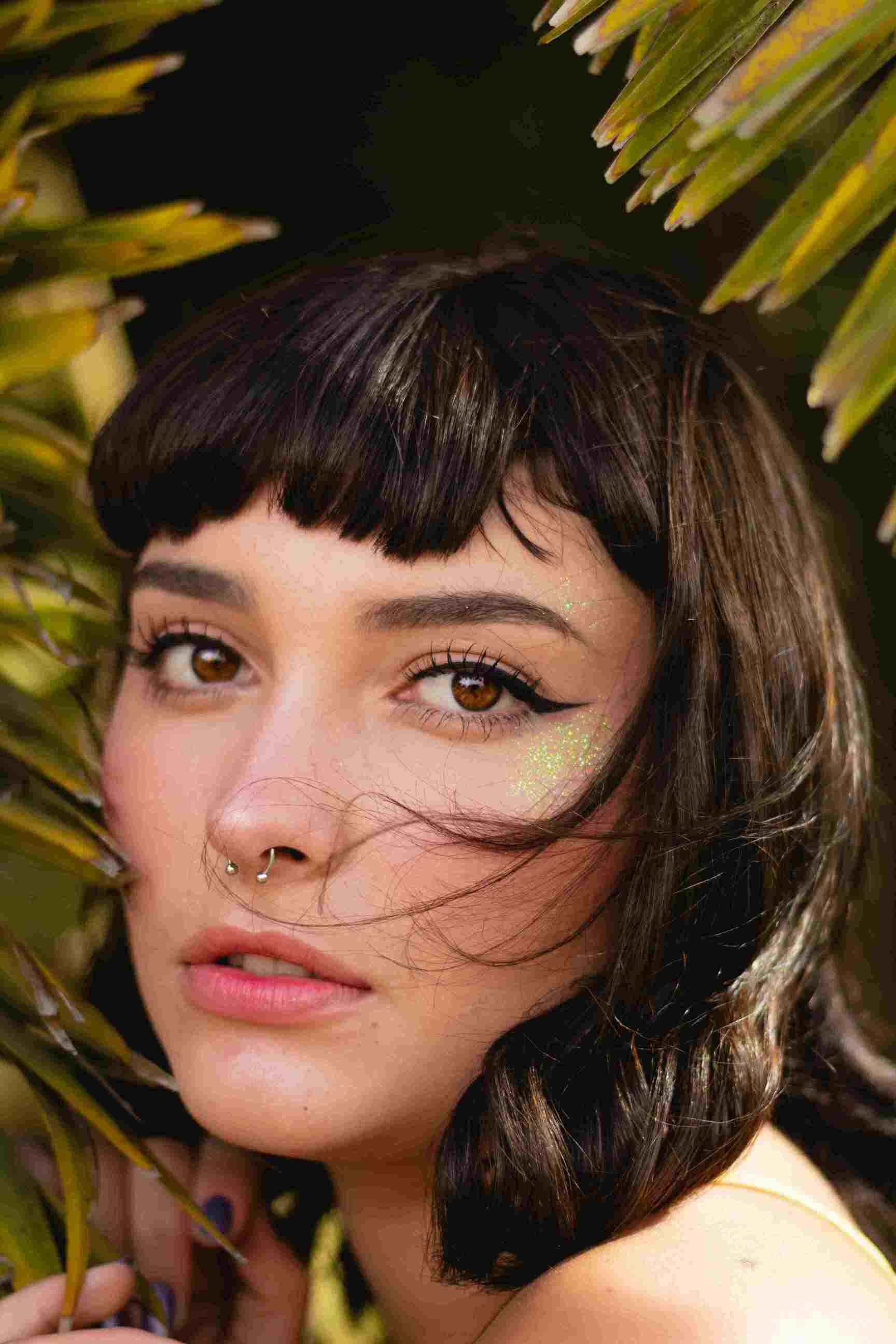 Portrait of a woman with luminous, even-toned skin, representing the results of effective skincare from rawnaqy.com