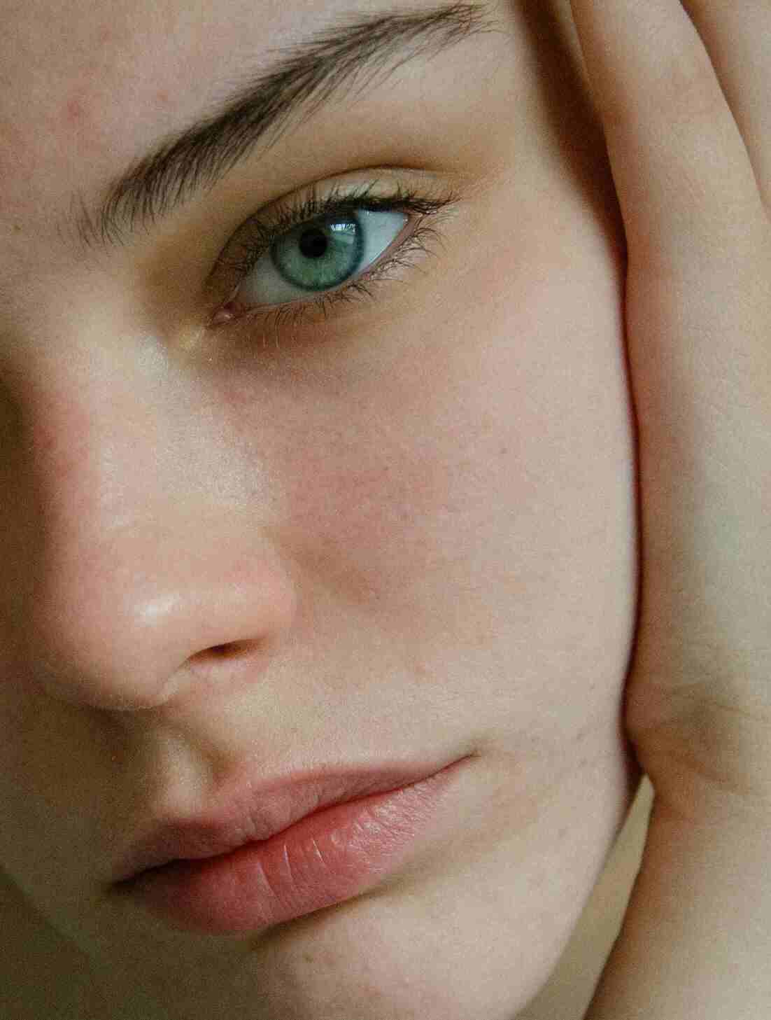 Close-up of smooth, glowing skin, emphasizing hydration and skin health due to the use of rawnaqy.com products.
